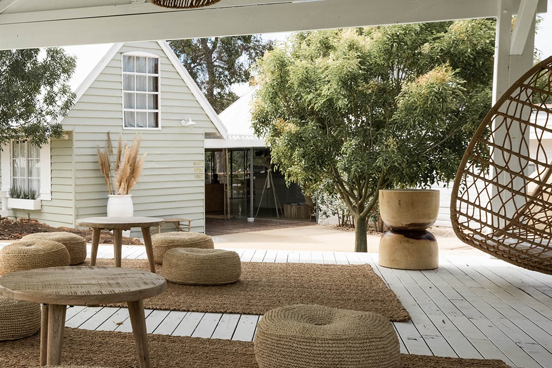 Meelup Farmhouse's deck with cushions and a hanging egg chair